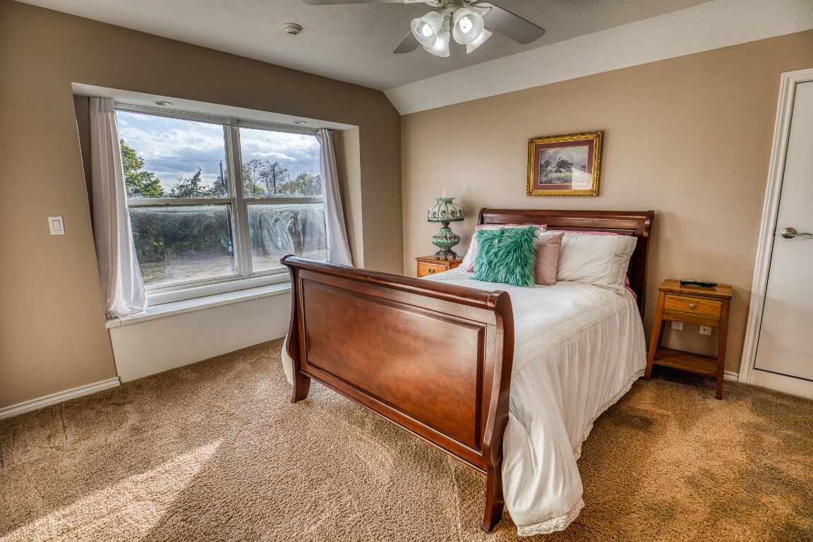 4701 Cedar Hill Road Brenham, TX 77833 - Photo 28 of 50 a bed sitting in a bedroom next to a window