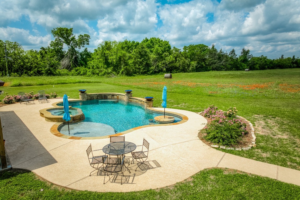 4701 Cedar Hill Road Brenham, TX 77833 - Photo 3 of 50 a view of a swimming pool and a yard