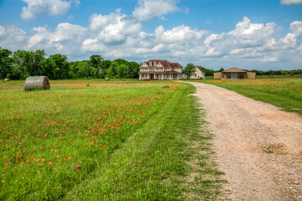 4701 Cedar Hill Road Brenham, TX 77833 - Photo 46 of 50 a view of a lake with houses in the back
