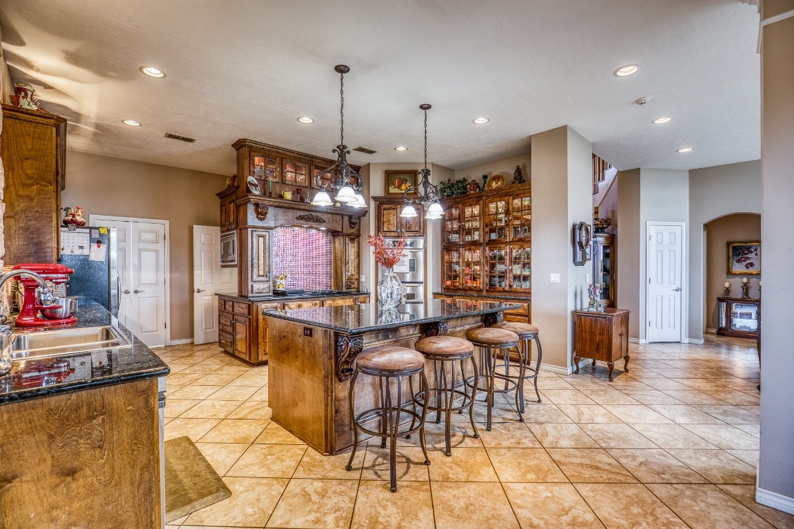 4701 Cedar Hill Road Brenham, TX 77833 - Photo 6 of 50 a large kitchen with a table and chairs