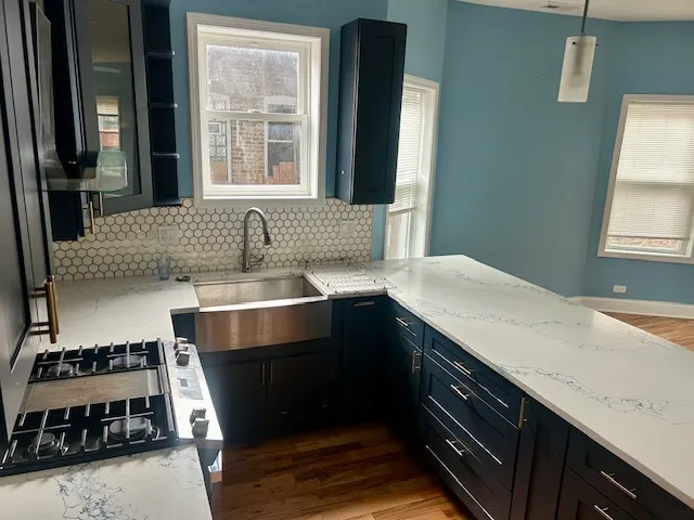 a kitchen with a sink and a stove top oven