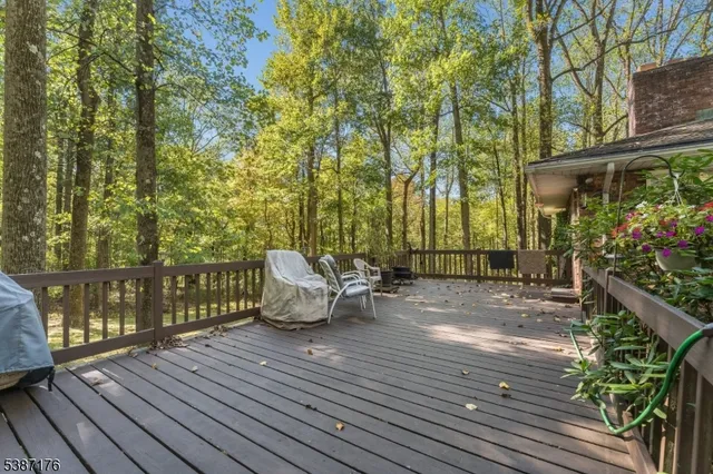 a view of a deck with chairs and wooden floor