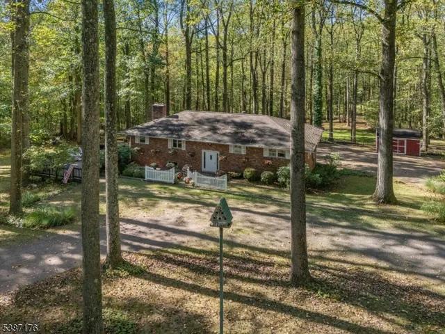 a view of a wooden house with a yard