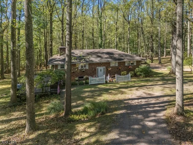 a view of a house with pool and sitting area