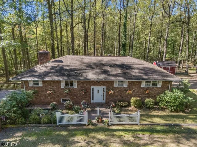a front view of a house with a yard and fountain