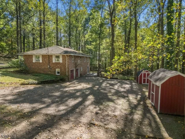 a view of a barn in the middle of a yard