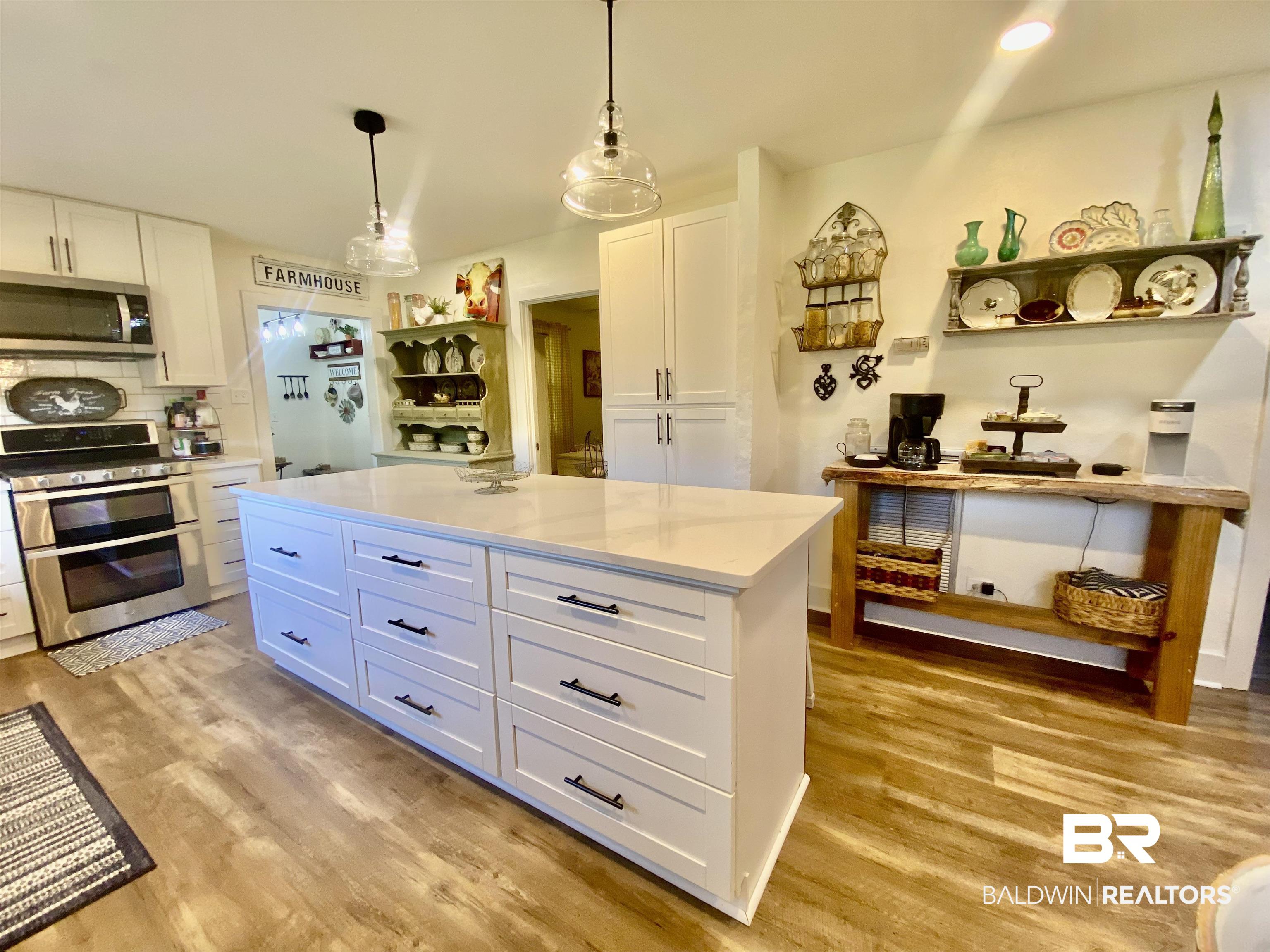 531 Highway 136 Monroeville, AL 36460 - Photo 13 of 48 Kitchen with light hardwood / wood-style floors, appliances with stainless steel finishes, and white cabinetry