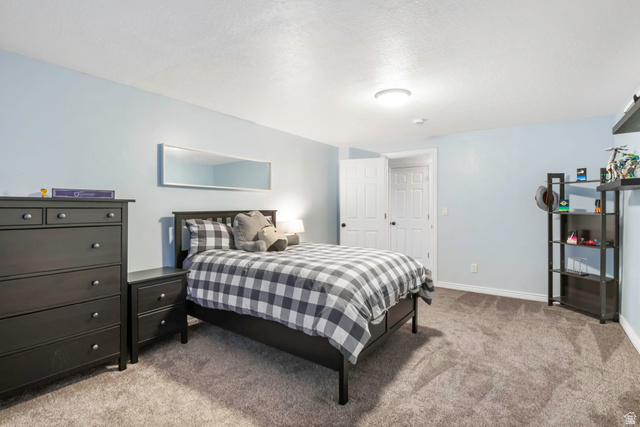 13176 Day Court Draper, UT 84020 - Photo 27 of 45 Bedroom featuring light colored carpet and a textured ceiling