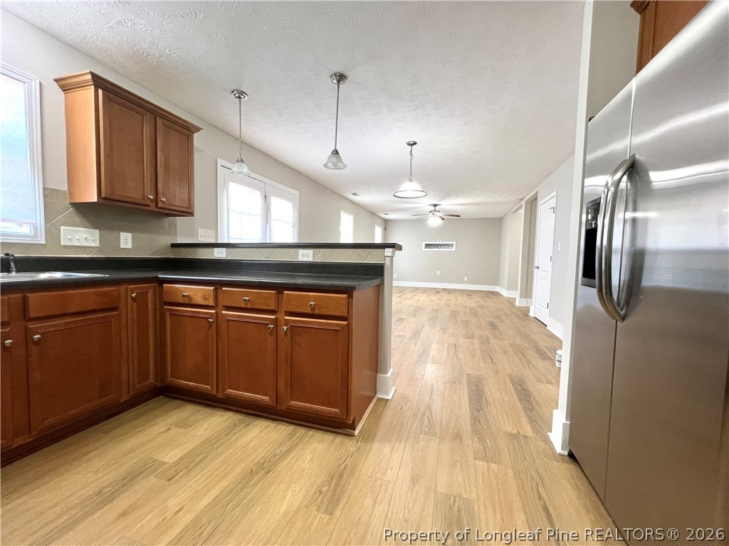 240 Declaration Drive Raeford, NC 28376 - Photo 11 of 37 a kitchen with stainless steel appliances granite countertop a sink a microwave cabinets and wooden floor