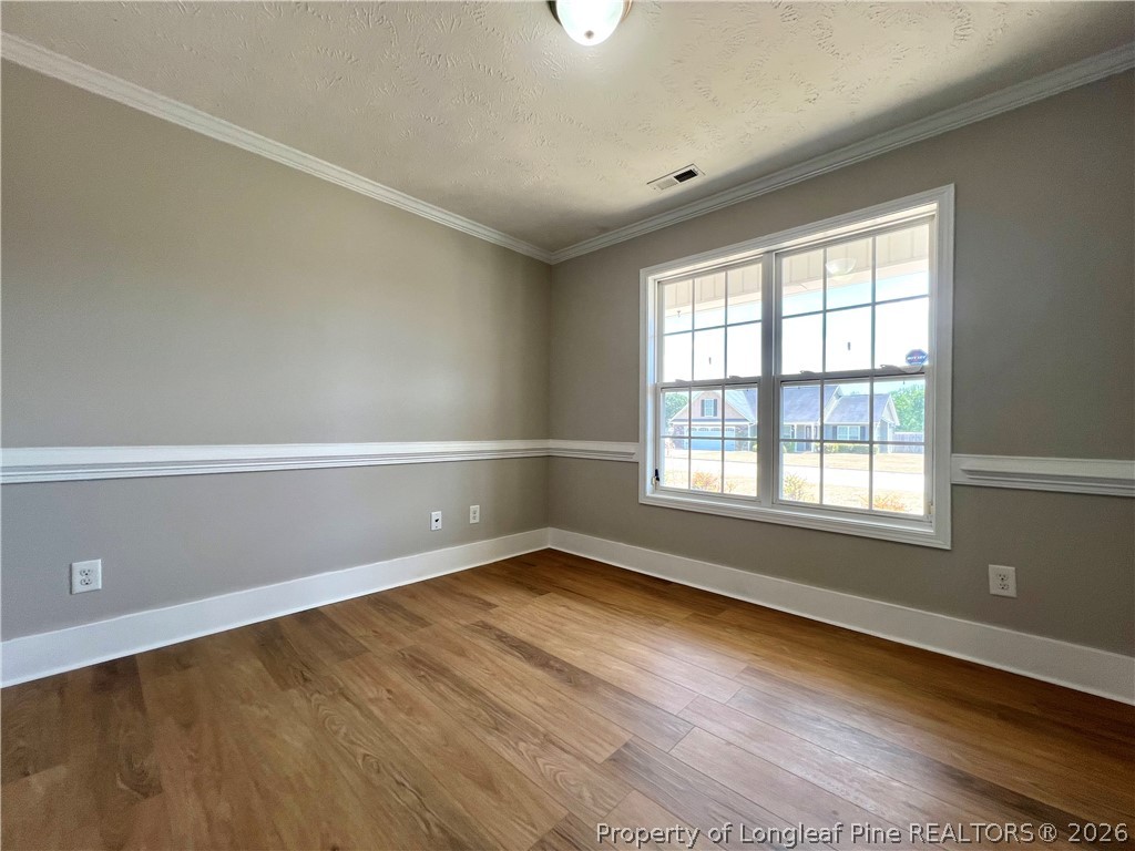 240 Declaration Drive Raeford, NC 28376 - Photo 16 of 37 a view of an empty room with wooden floor and a window