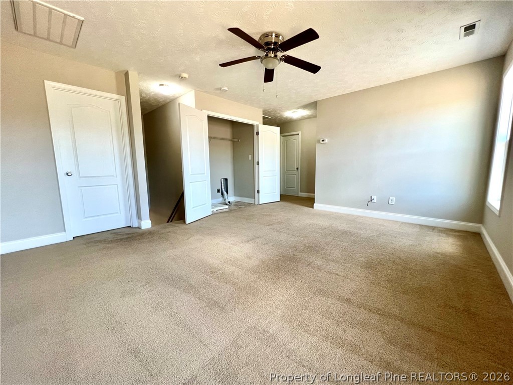 240 Declaration Drive Raeford, NC 28376 - Photo 29 of 37 an empty room with a ceiling fan and a window