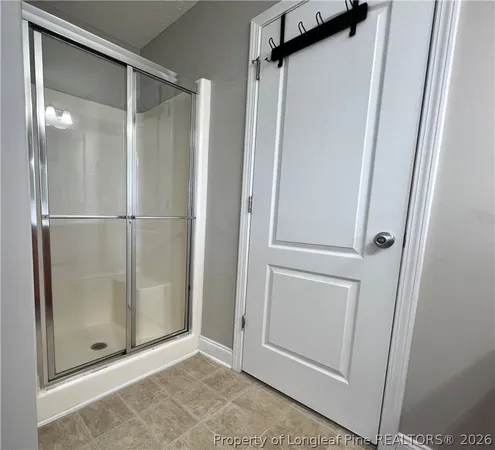 a bathroom with a glass shower door