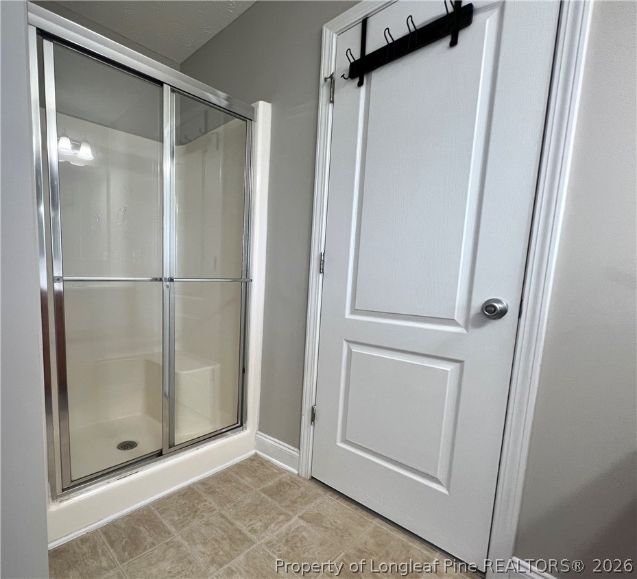240 Declaration Drive Raeford, NC 28376 - Photo 31 of 37 a bathroom with a glass shower door