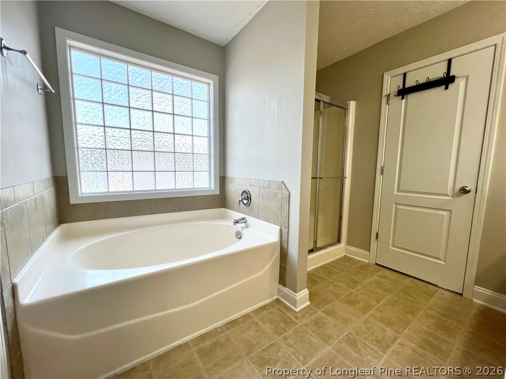 240 Declaration Drive Raeford, NC 28376 - Photo 32 of 37 a spacious bathroom with a tub shower and a sink