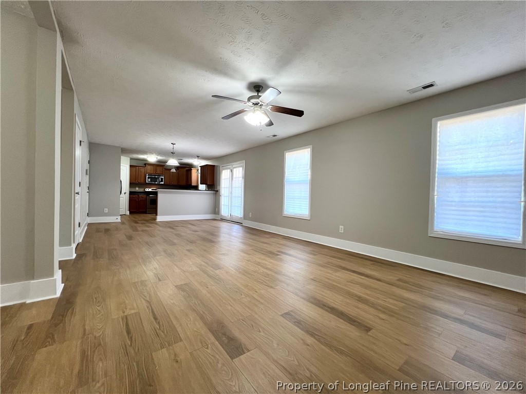 240 Declaration Drive Raeford, NC 28376 - Photo 6 of 37 a view of an empty room with window and wooden floor