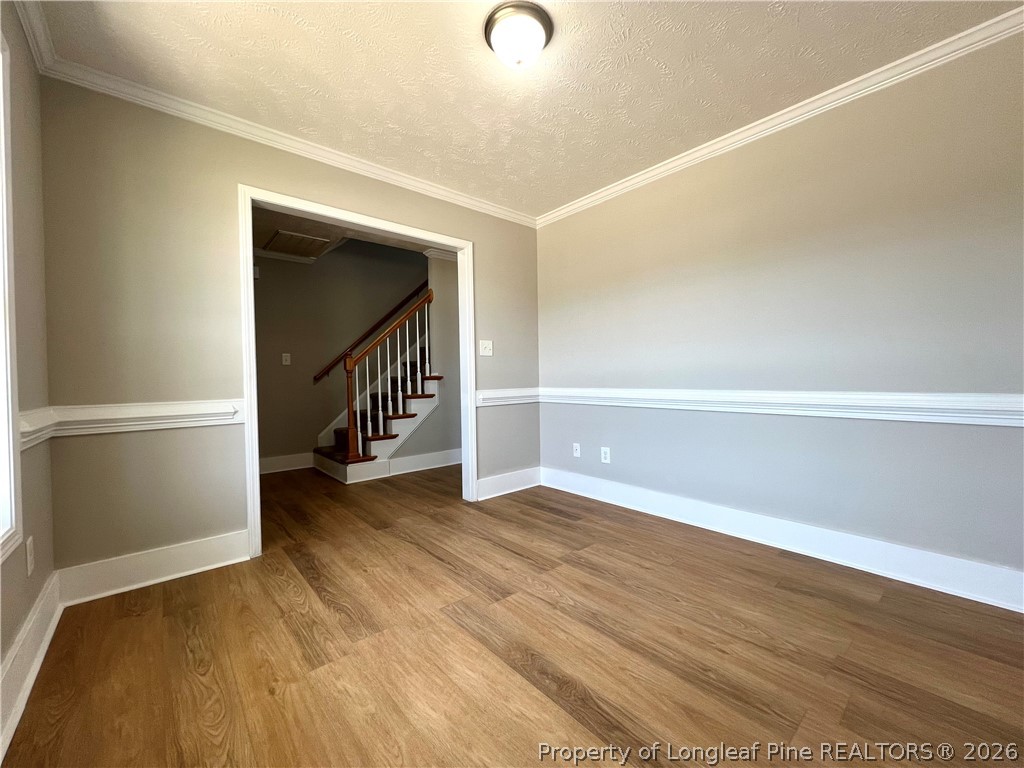240 Declaration Drive Raeford, NC 28376 - Photo 8 of 37 a view of an empty room with wooden floor and a window