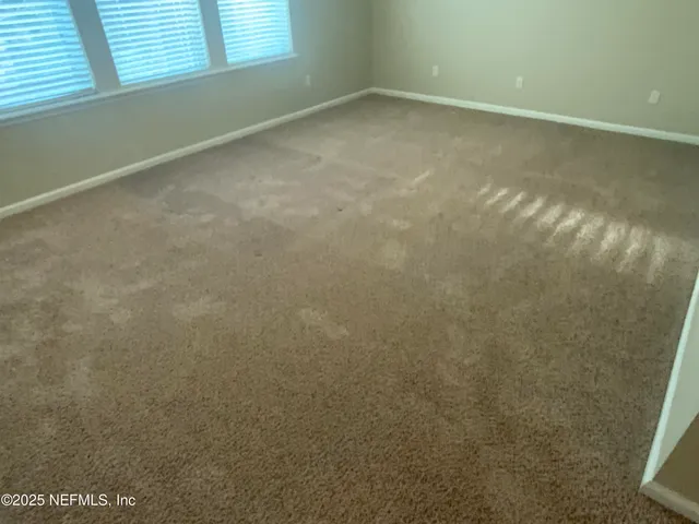 an empty room with closet area