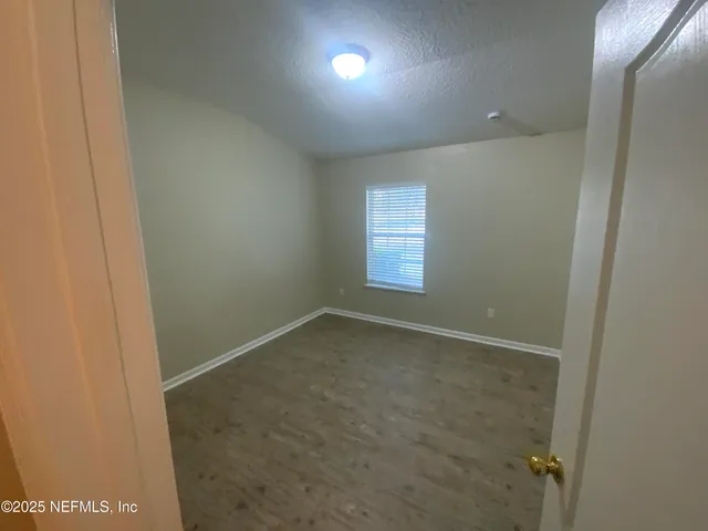 a bathroom with a granite countertop sink a mirror and a bathtub