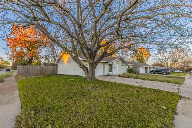 a view of a house with yard and a tree
