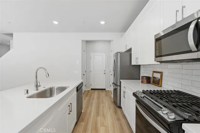 a kitchen with a sink stove and refrigerator