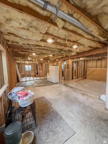680 Timpie Road Tooele, UT 84074 - Photo 19 of 31 Exposed ceiling joists with insulation, bare wall studs, and concrete flooring