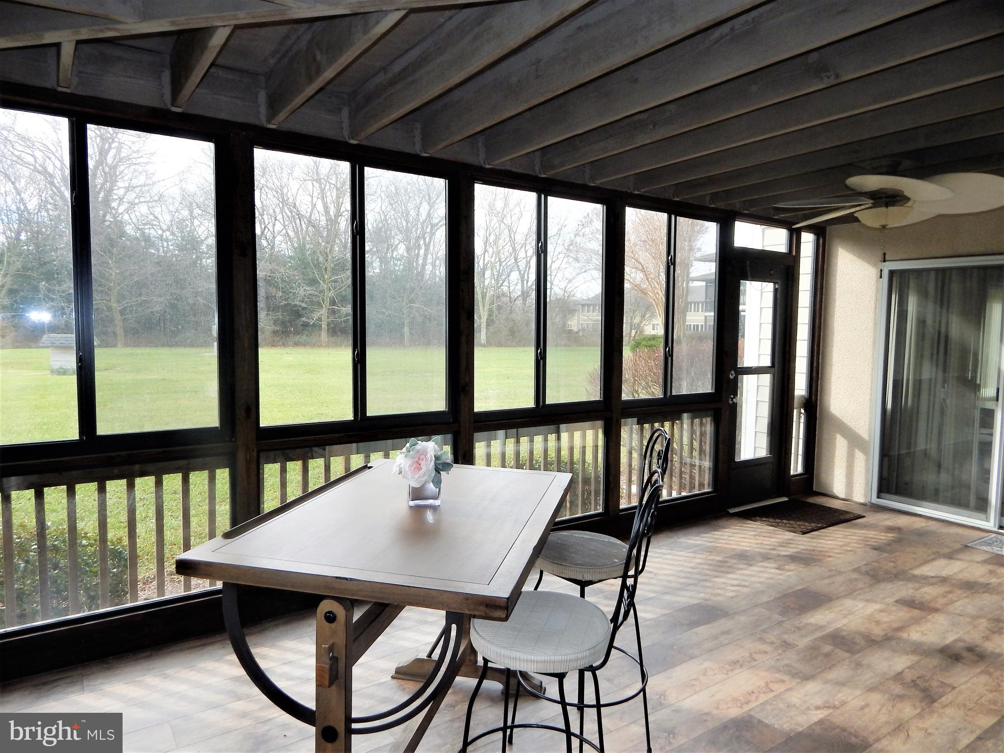 18530 Drayton Hall Road, Unit 8 Lewes, DE 19958 - Photo 15 of 16 Sunroom view of grassy area
