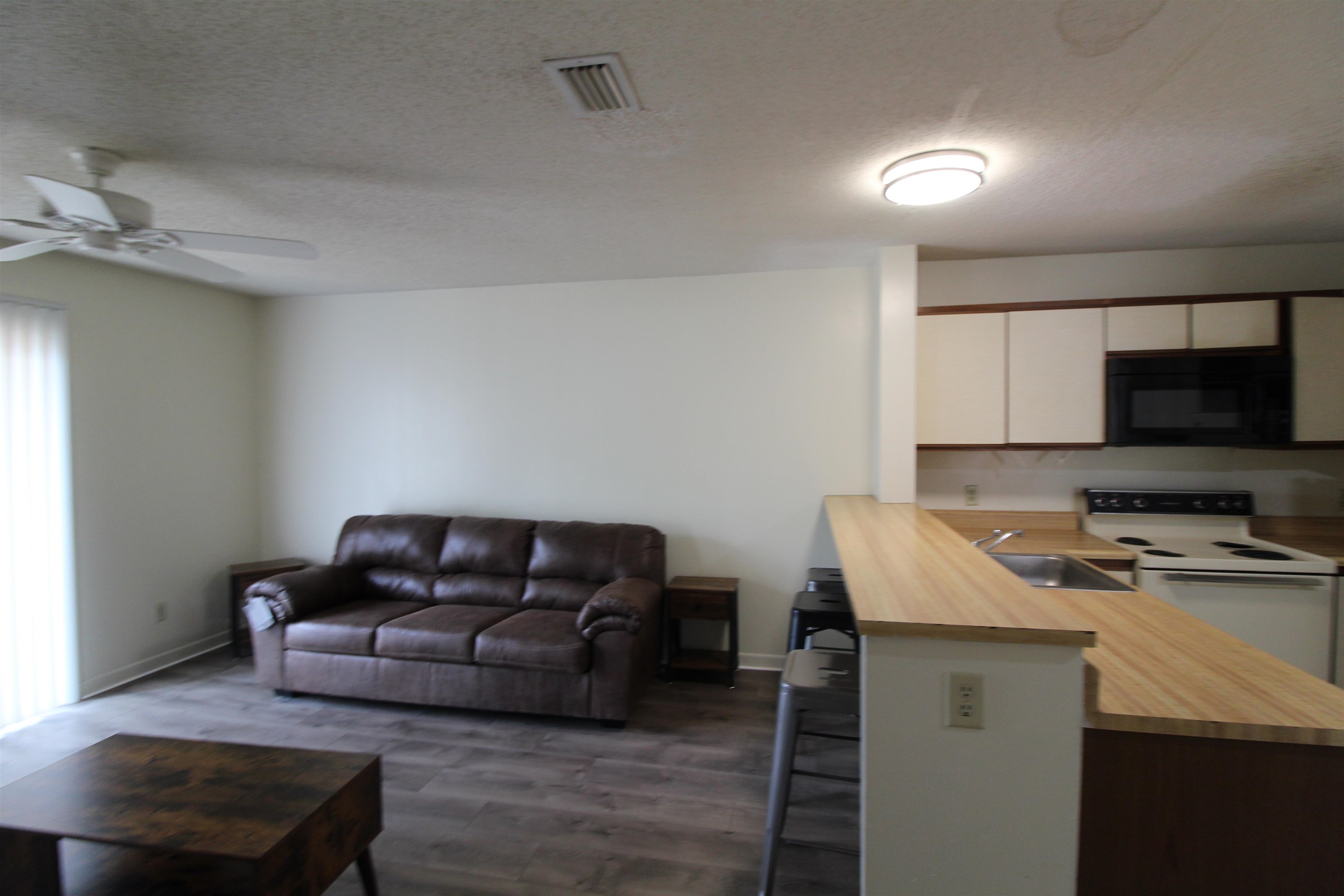 1336 Hunters Road, Unit G Harrisonburg, VA 22801 - Photo 23 of 42 a living room with furniture and a flat screen tv
