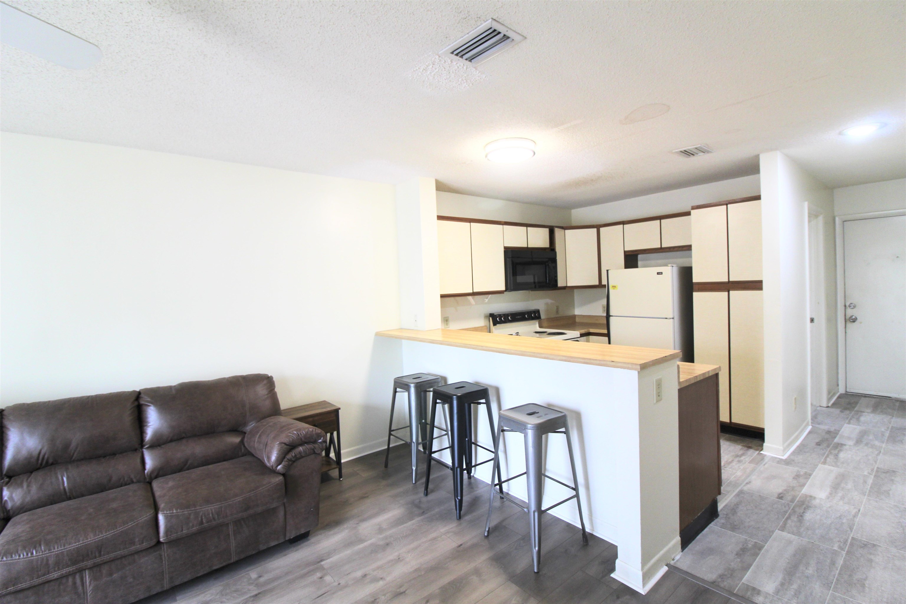 1336 Hunters Road, Unit G Harrisonburg, VA 22801 - Photo 26 of 42 a living room with stainless steel appliances furniture a refrigerator and a kitchen view