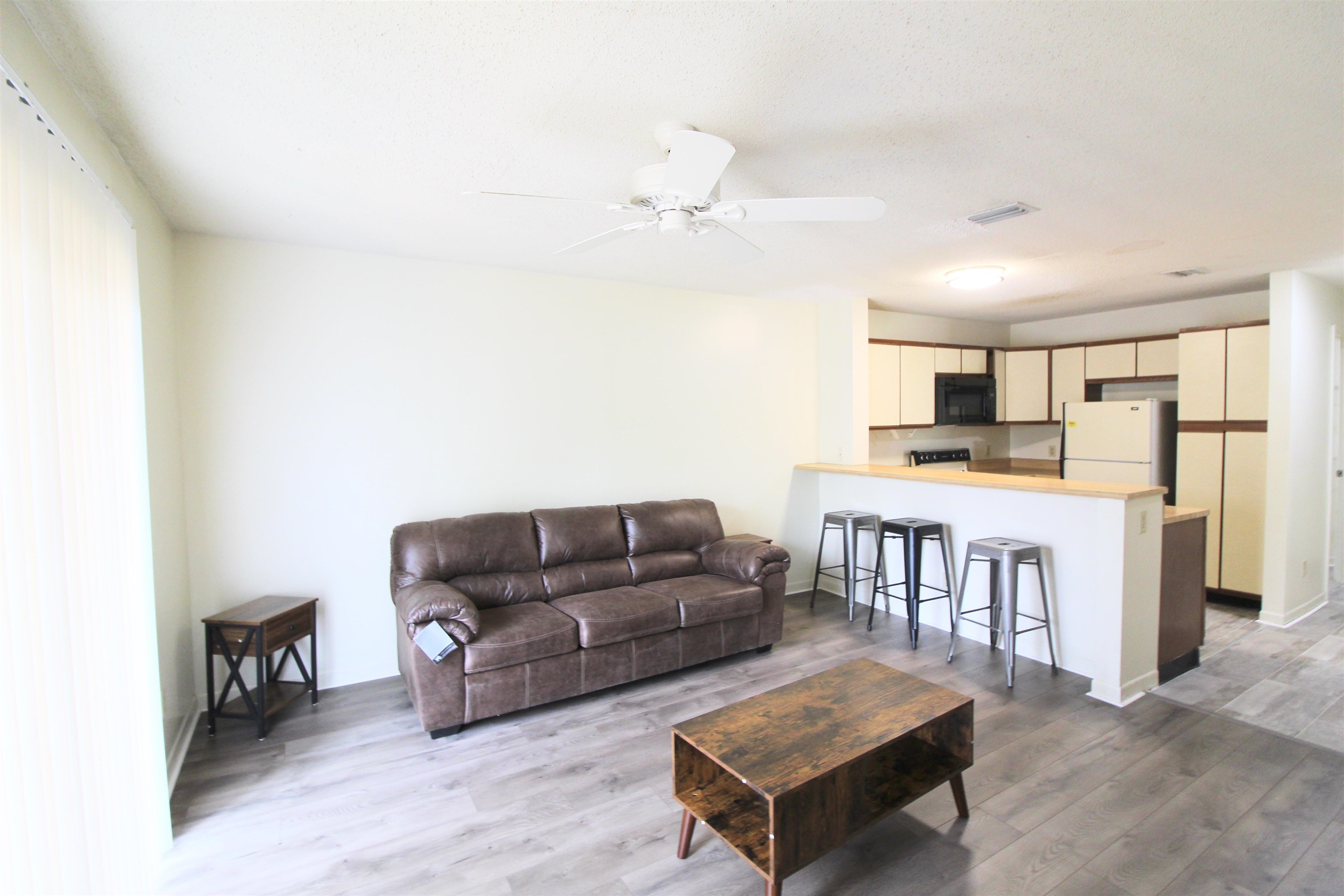 1336 Hunters Road, Unit G Harrisonburg, VA 22801 - Photo 29 of 42 a living room with furniture and a wooden floor
