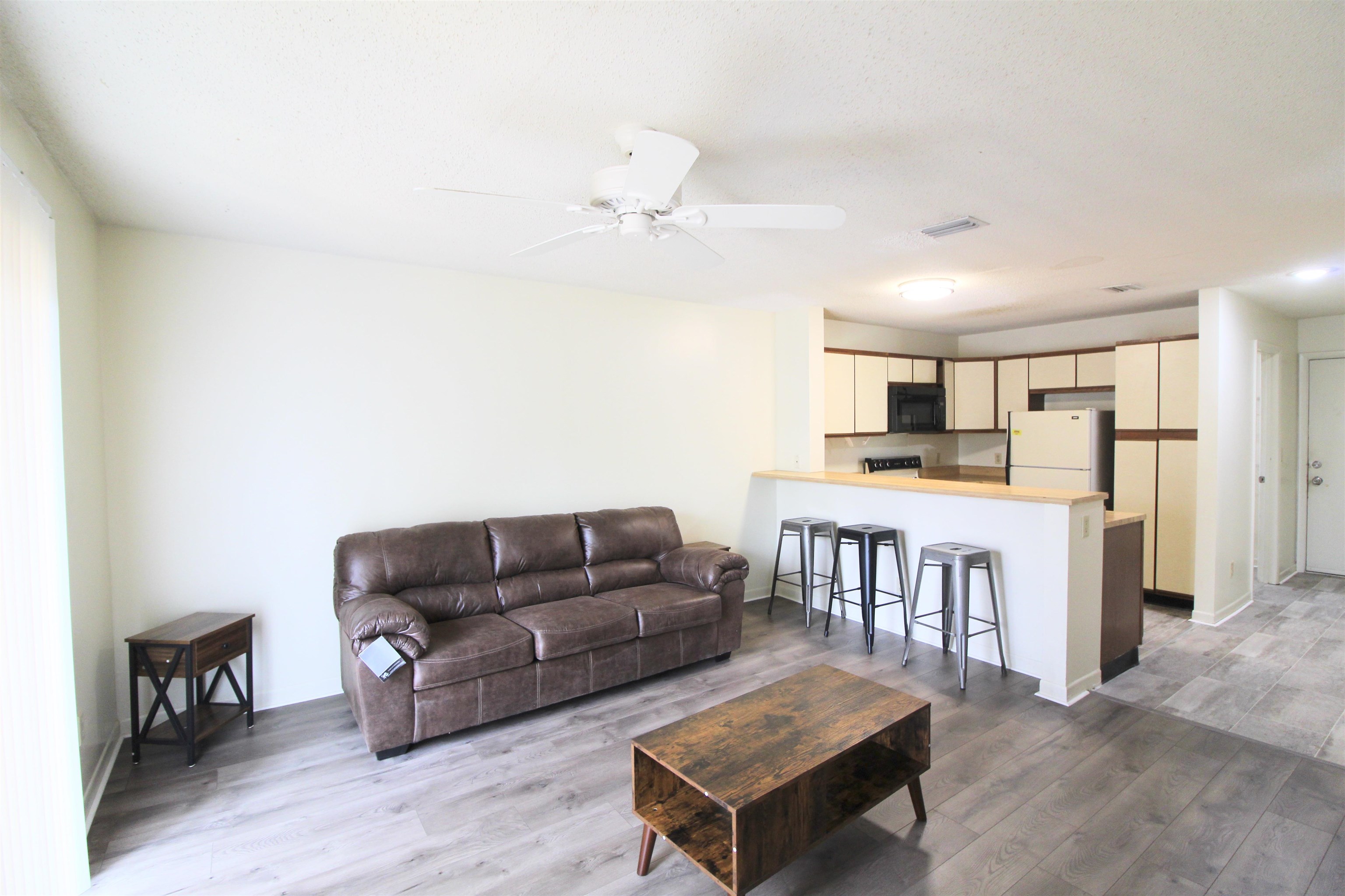 1336 Hunters Road, Unit G Harrisonburg, VA 22801 - Photo 30 of 42 a living room with kitchen island furniture and a kitchen view