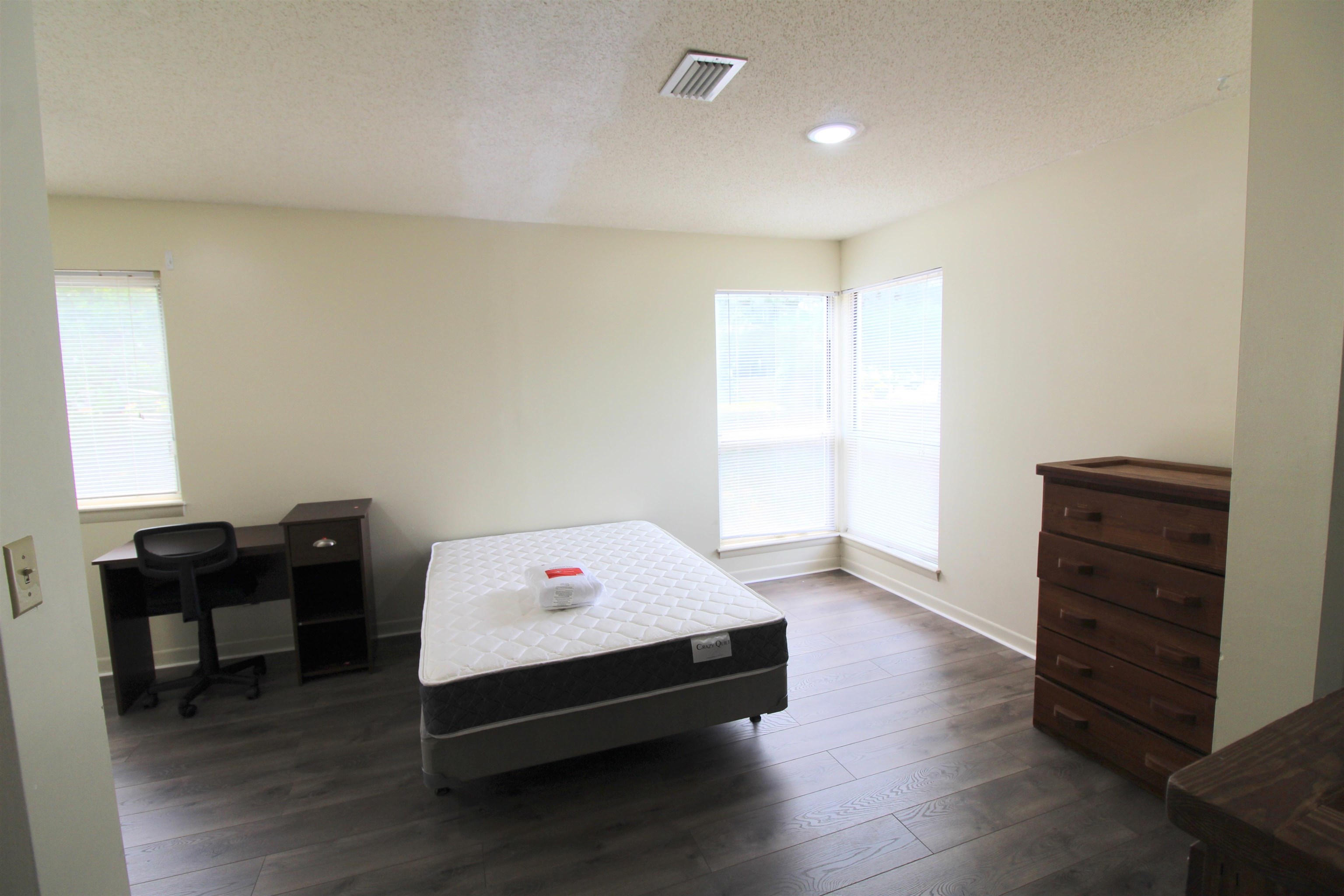 1336 Hunters Road, Unit G Harrisonburg, VA 22801 - Photo 33 of 42 a bedroom with a bed and wooden floor