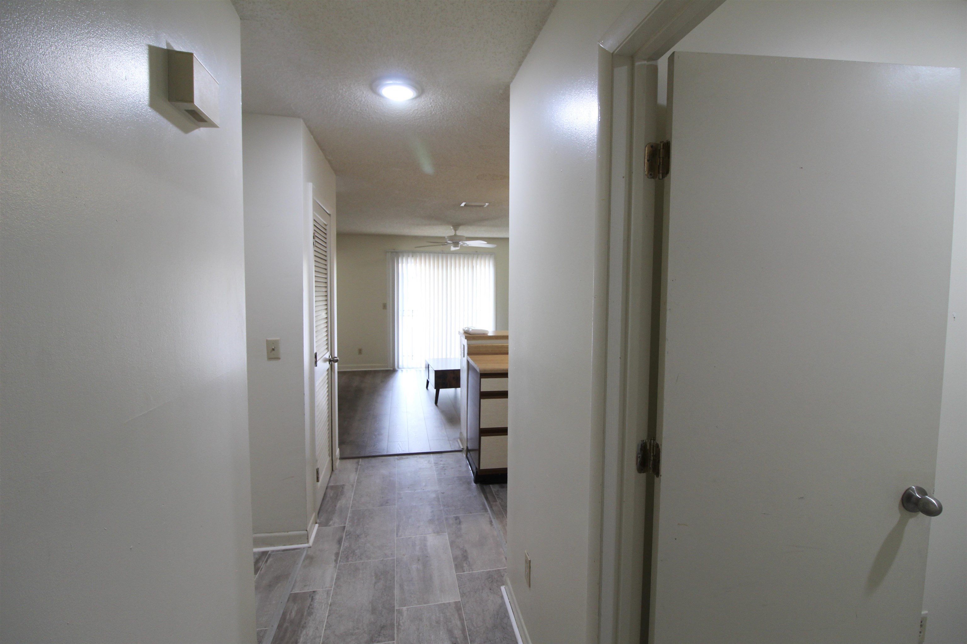 1336 Hunters Road, Unit G Harrisonburg, VA 22801 - Photo 6 of 42 a view of a hallway with wooden floor and a bathroom