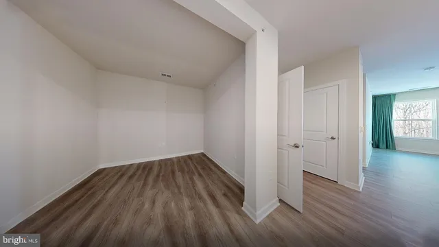 a view of a room with wooden floor