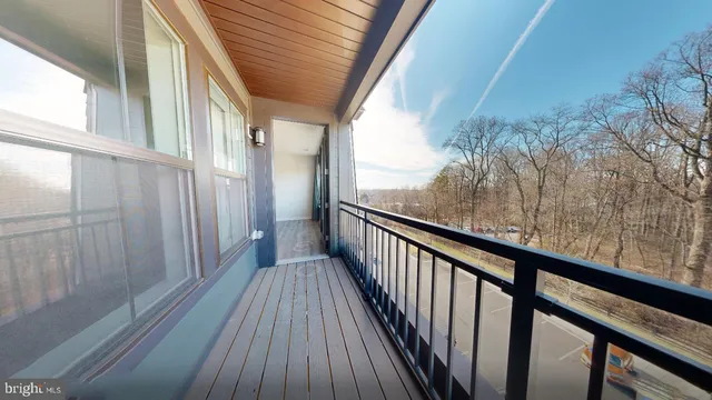 a view of a balcony with wooden floor