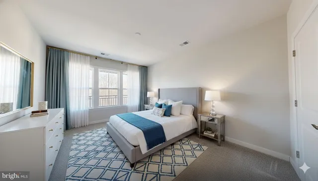 a spacious bedroom with a bed and a window