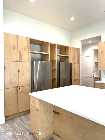 a kitchen with stainless steel appliances a refrigerator and a counter top space