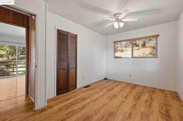 a view of an empty room with wooden floor