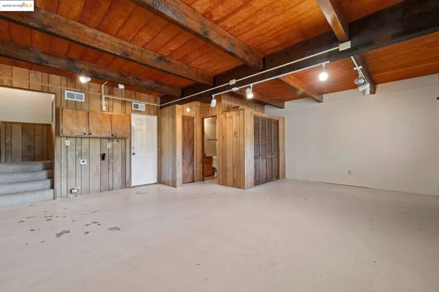 a view of empty room with wooden walls