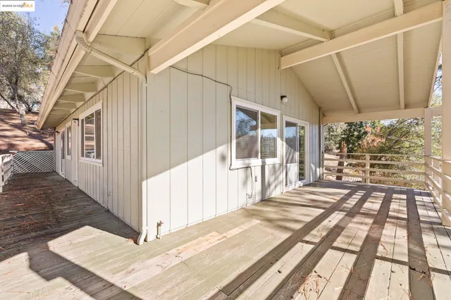a view of a house with yard and sitting area