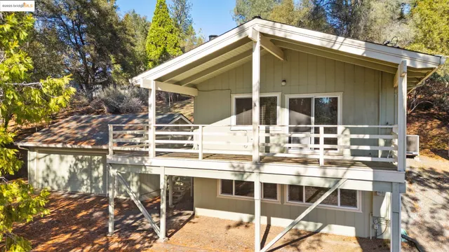 a balcony with table and chairs