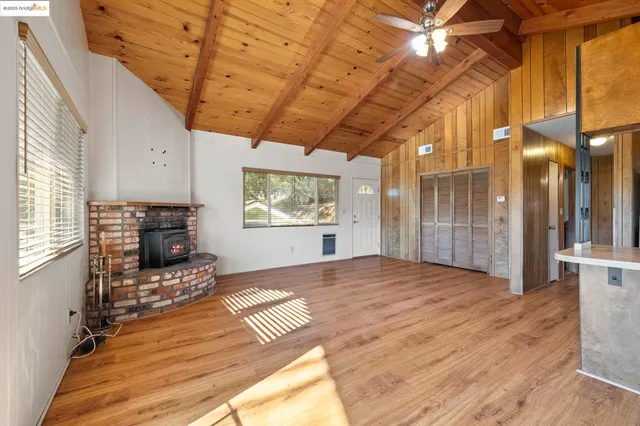 a view of a kitchen with furniture and wooden floor