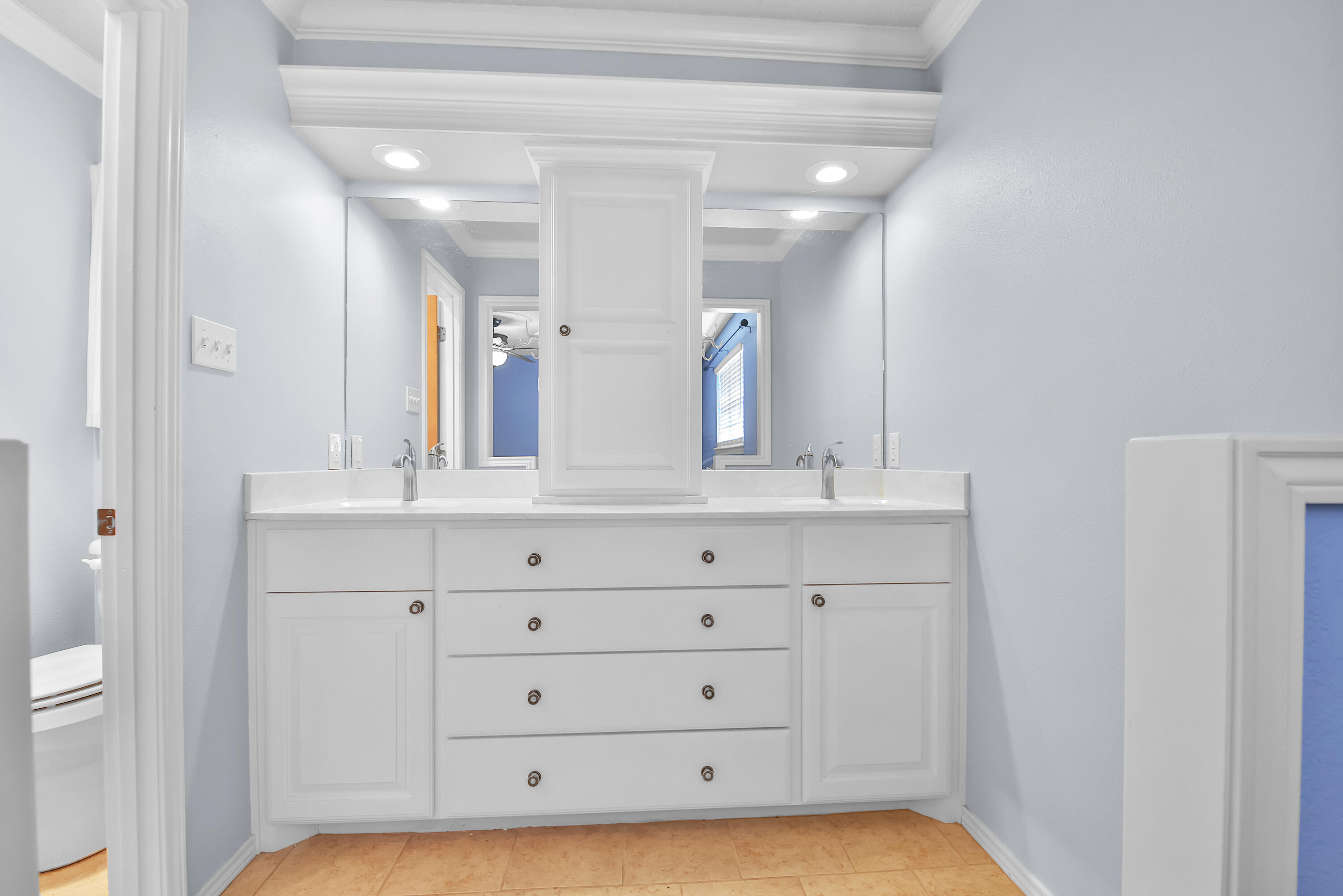 4805 73rd Street Lubbock, TX 79424 - Photo 15 of 26 a bathroom with a double vanity sink and mirror