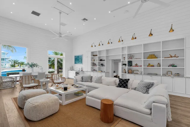 a large kitchen with kitchen island a large counter top space a sink stainless steel appliances and cabinets