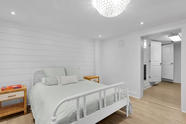 a dining room with furniture a potted plant and a floor to ceiling window