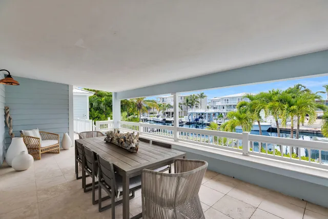 a bedroom with two beds and a large window