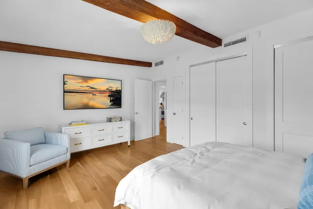 a bedroom with a bed and a table in it