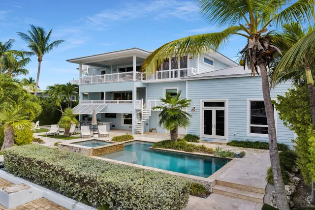 a living room with furniture kitchen view and a large window