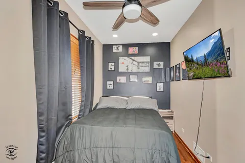 a bedroom with a bed and a large window