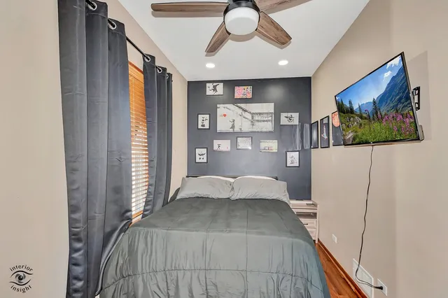a bedroom with a bed and a large window