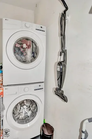 a view of a storage and utility room with a washer dryer